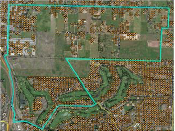 outline of a Census Tract over aerial imagery with farm fields and scattered houses, with populated points over houses
